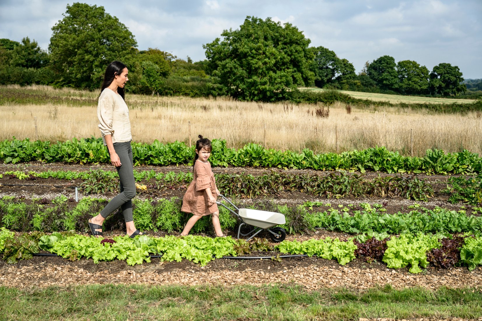 Mother and 5 year old daughter in market garden